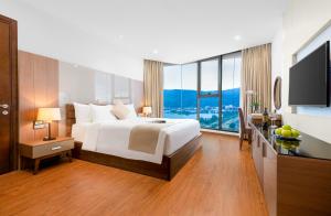 um quarto com uma cama grande e uma janela grande em Alan Sea Hotel Danang em Da Nang