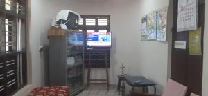 a corner of a room with a door and a shelf at VALIYATH HOLIDAYS HOMESTAY in Munroe Island