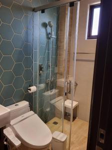 a bathroom with a toilet and a glass shower at 傅居52 in Tainan
