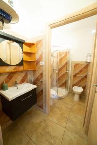a bathroom with a sink and a shower and a toilet at WEST SARDINIA APARTMENT 3 in Càbras +41 photos
