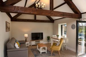 a living room with a couch and a tv at K2Cottages 