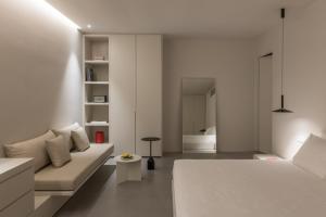 a white room with a bed and a couch at Aesthesis Boutique Villa Trace in Fira +18 photos