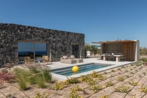 a villa with a swimming pool in the desert at Aesthesis Boutique Villa Trace in Fira