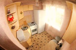 an overhead view of a small kitchen with a window at Dekabrist apartment at petrovsko-zavodskaya 31 in Chita