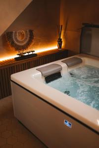 a bathroom with a bath tub with at Comme chez Soye - Private Wellness in Soye +24 photos