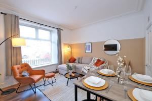 een woonkamer met een bank en een tafel bij Sensational West End Living with Bicocca Stays in Aberdeen