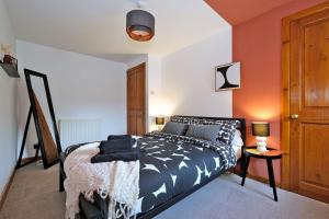 a bedroom with a bed with black and white sheets at Sensational West End Living with Bicocca Stays in Aberdeen