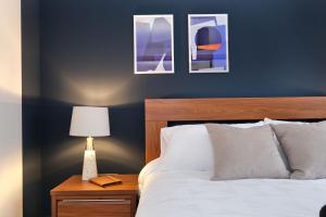 a bedroom with a bed and a table with a lamp at Sensational West End Living with Bicocca Stays in Aberdeen