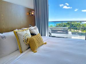 a bedroom with a bed with a view of the ocean at Minimi Inn-Sailrock Beach House in Eluan