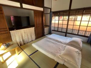 a bedroom with a bed and a flat screen tv at 南庄東村宿舍Nanzhuang Dongchon Homestay in Nanzhuang