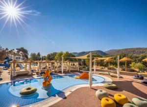 a pool at a resort with a slide at Valamar Amicor Green Resort in Stari Grad