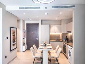 a kitchen and dining room with a table and chairs at STAY BY LATINEM Luxury 2BR Holiday Home CV A1409 near Burj Khalifa in Dubai