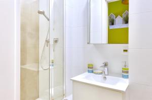 a white bathroom with a sink and a shower at Pokój 24E in Sobieszewo +9 photos
