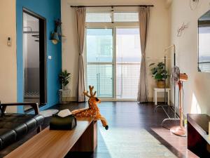 a living room with a couch and a stuffed animal on a table at 艾迪行旅民宿 in Ruisui