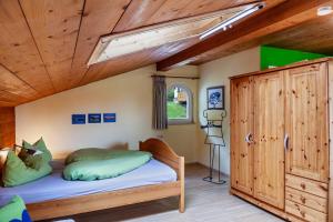 a bedroom with a bed and a wooden ceiling at Ferienwohnung Kleisl in Grainau
