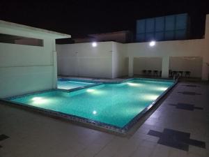 a large swimming pool in a building at night at Hotel Mutiara in Gua Musang
