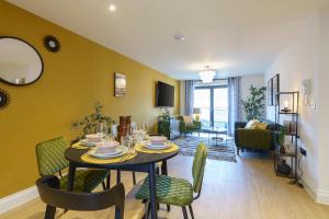 a dining room with a table and chairs and a living room at Euphorbia - 1 Bedroom Luxury Apartment by Mint Stays in Bristol