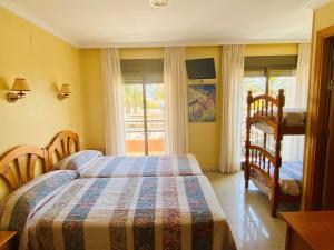 a bedroom with two beds and a window at Hostal L'Anfora in Denia