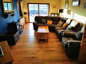 a living room with a couch and a coffee table at Picturesque Riverside Home in Cahersiveen