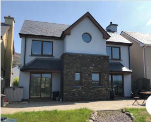 a large white house with a brick at Picturesque Riverside Home in Cahersiveen