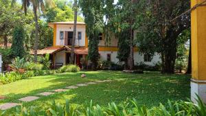 a house in the middle of a yard at Red Door Hostel Anjuna in Anjuna