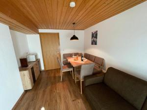 a dining room with a table and a couch at Gästehaus Garber in Stumm