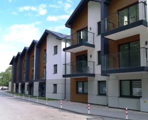 a row of apartment buildings on a street at Pokój 24E in Sobieszewo