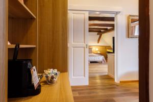 a room with a door leading to a bedroom at Hotel Historia & Historante in Veszprém