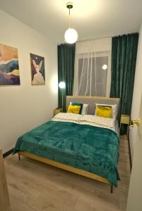 Posteľ alebo postele v izbe v ubytovaní Apartament Witold