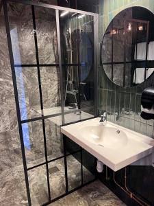 a bathroom with a sink and a mirror at Hotell Älvdalen in Älvdalen