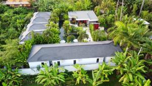 an aerial view of a building with trees and plants at Le Chien Rouge in Lovina