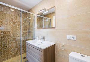 a bathroom with a sink and a shower at L’Ancora Suite in Jávea +18 photos