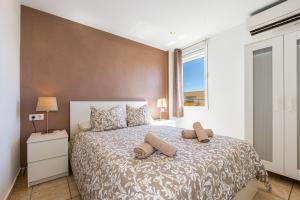 a bedroom with a large bed with two pillows on it at L’Ancora Suite in Jávea