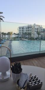 a table with a bowl of food and a view of a pool at Luxury sea view Apartment In Address Hotel Fujairah in Fujairah