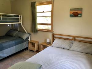 a bedroom with two beds and a window at Nunyara in Aireys Inlet