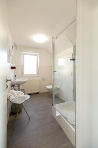 a bathroom with a shower and a sink and a tub at Appartement Burgund in Oedheim