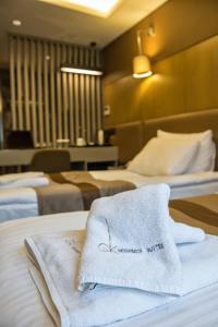 Postel nebo postele na pokoji v ubytování GK Regency Suites Hotel