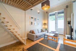 a living room with a couch and a staircase at Urban Stuck in Berlin