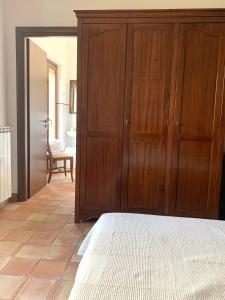 a bedroom with a wooden cabinet and a bed at Agriturismo San Pietro in Gangi