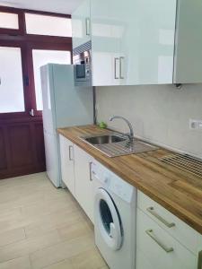 a kitchen with a sink and a washing machine at Stylish one bedroom apartment near the Drago Tree in Icod de los Vinos