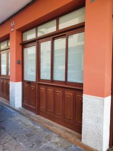 a row of wooden garage doors on a building at Stylish one bedroom apartment near the Drago Tree in Icod de los Vinos