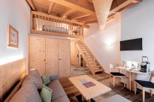 a living room with a couch and a table at Hotel Sarain - Val Saraina Resort Lenzerheide in Lenz