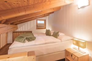 a bedroom with a bed in a room with wooden ceilings at Hotel Sarain - Val Saraina Resort Lenzerheide in Lenz +96 photos