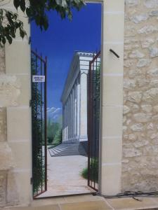 an open gate with a view of a building at Maison du Théâtre Saint Bonnet in Bourges