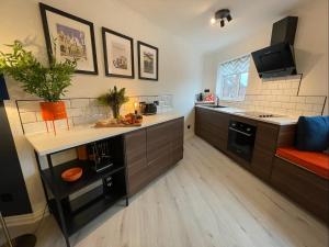 a kitchen with brown cabinets and a counter top at East Walls Apartment in Chichester