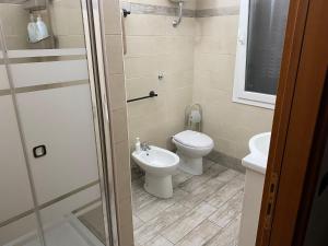 a bathroom with a toilet and a sink at B&B LA MERAVIGLIA in Borgo Grappa