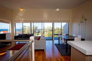 a kitchen and living room with a couch and a table at Hopetoun Motel & Chalet Village in Hopetoun