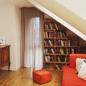a living room with a book shelf filled with books at ArtHouse Pelnik in Łukta