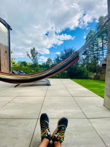a person with their feet up in a hammock at ArtHouse Pelnik in Łukta