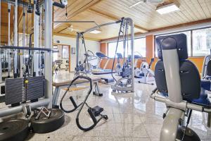a gym with a bunch of exercise equipment in it at Saalbach Suites by ALPS RESORTS in Saalbach-Hinterglemm